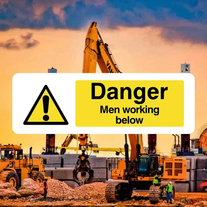 Men Working Below Sign